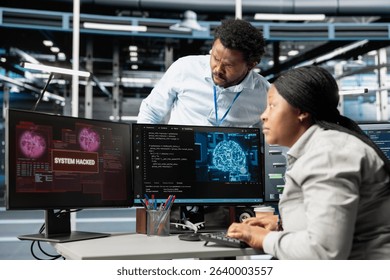 IT staff members in artificial intelligence server hub facility trying to protect servers from hackers. AI data center cybersecurity division colleagues protecting rigs during security breach