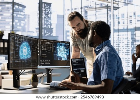 IT staff members testing and deploying artificial intelligence programs and systems. Team of computer scientists checking AI code, sitting at desk chair in office, doing brainstorming