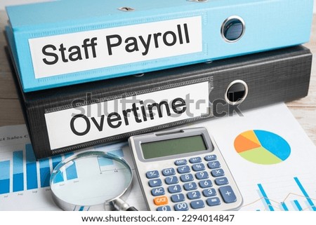 Staff Payroll, Overtime. Binder data finance report business with graph analysis in office.