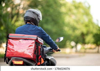 The staff prepares the delivery box on the motorcycle for delivery to customers. - Shutterstock ID 1786024076