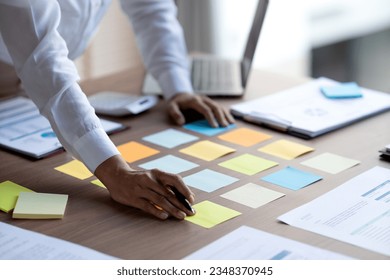 staff preparing to fill information on colorful sticky notes for meetings to pick ideas data for work or business that require decision making - Shutterstock ID 2348370945
