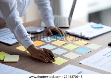 staff preparing to fill information on colorful sticky notes for meetings to pick ideas data for work or business that require decision making ストックフォト © 