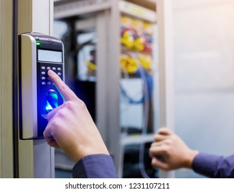 Staff push down electronic control machine with finger scan to access the door of control room or data center. The concept of data security or data access control.