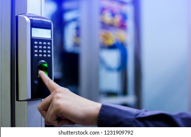 Staff push down electronic control machine with finger scan to access the door of control room or data center. The concept of data security or data access control.
