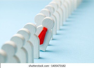 Staff recruitment. Headhunting. Many employees and the choice of a leader from the crowd. HR. A lot of white businessman and one in a red tie on a blue background. - Shutterstock ID 1405473182