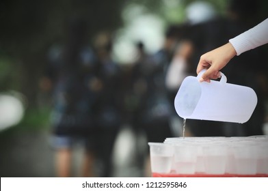 Staff Rinse the glass at Water-stop for Runners to take a cup of water along the route of a marathon  - Powered by Shutterstock