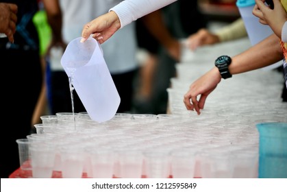 Staff Rinse the glass at Water-stop for Runners to take a cup of water along the route of a marathon  - Powered by Shutterstock