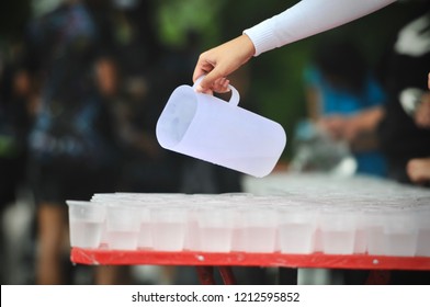 Staff Rinse the glass at Water-stop for Runners to take a cup of water along the route of a marathon  - Powered by Shutterstock