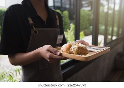 Staff Serving Croissants To Customers