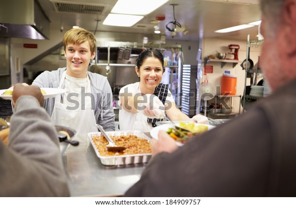 Staff Serving\
Food In Homeless Shelter\
Kitchen