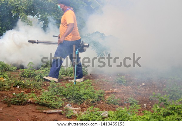 \
Staff are using fogging machine to spray fogging\
to get rid of mosquitoes, to prevent dengue fever, take blurred\
images