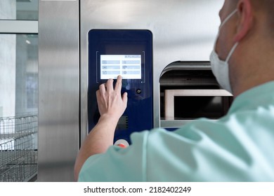 Staff Using A Machine To Sterilise Hospital Supplies