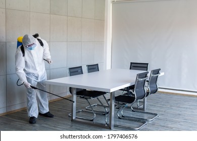 Staff wear PPE suit cleaning Disinfection at meeting room amid the coronavirus epidemic Professional team disinfection efforts Infection prevention and control of epidemic Protective suit and mask. - Powered by Shutterstock