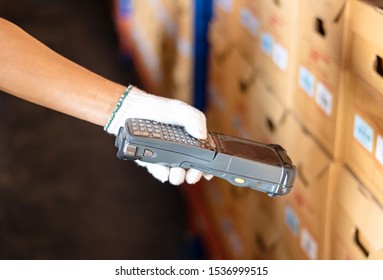 Staff Wearing White Gloves Holding A Barcode Reader. The Product Has A Sticker Using Modern Technology To Read Values. Makes Business And Warehouse Management Convenient And Easy.