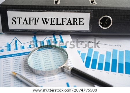 Staff Welfare. Binder data finance report business with graph analysis in office.
