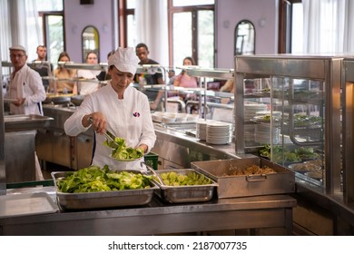 Staff Worker Preparing Food For Students In School Canteen. Lunch Break. Education People And Students Eating Food Meals School Cafeteria. Belgrade, Serbia 17.05.2022