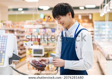 Staff working at the cash register in a supermarket