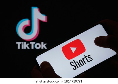 Stafford / UK - September 14 2020: Youtube Shorts App Logo Seen On The Silhouette Of Smartphone In A Hand And Dark TikTok Logo On The Blurred Background. Real Photo, No Edit In Post.