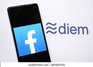 Stafford, United Kingdom - December 1 2020: Facebook Currency Logo On The Smartphone And Blurred Diem Logo On The Background. Diem Is A New Crypto Currency Form Facebook.