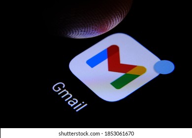Stafford, United Kingdom - November 12 2020: Google Gmail app and finger above it ready to press it seen on the screen of smartphone. Google redesigned the app logo in 2020.
