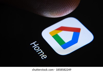 Stafford / United Kingdom - November 12 2020: Google Home app and finger tip above it ready to press the screen. The new application look introduced in 2020.