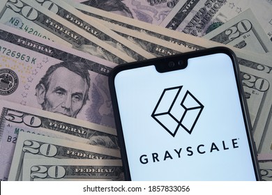 Stafford  United Kingdom - November 15 2020: Grayscale Bitcoin Trust company logo seen on the screen of smartphone, placed on dollar bills.