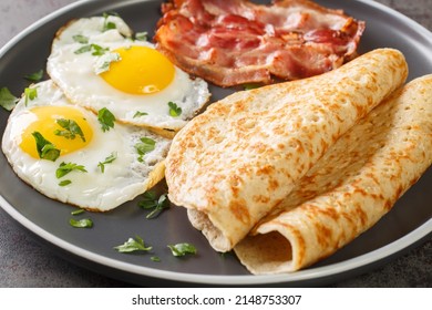 Staffordshire Oatcakes With Bacon And Fried Eggs Close-up In A Plate On The Table. Horizontal
