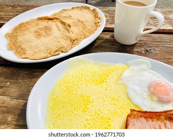 Staffordshire Oatcakes With Grilled Cheese, Bacon, Fried Egg On White Plates Served With Mug Of Coffee