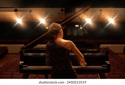 Stage, concert and back of woman with piano for performance, entertainment and talent show. Musician, pianist and person practice playing on instrument for melody, music and symphony for theatre - Powered by Shutterstock