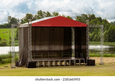 Stage For Concert Or Show On The City Park. Metal Frame Construction For Light, Sound And Video Equipment . No People At Day Time.