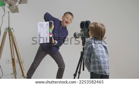 Stage director and actor, children play with video camera, funny child dance