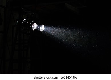 Stage Light With Dust And Sparkles In Ray Of Light In Dark Interior