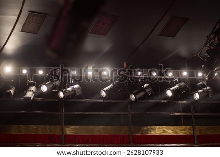 Stage lighting setup illuminates theater performance area for evening show