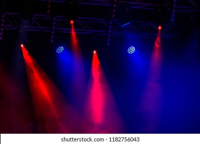 Stage Lights. Background In The Show. Light In Dark. The Interior Of The Theater Is Illuminated By Projector. Stage Lights And Smoke Scenes During The Concert. Laser Show On The Stage Of Theater