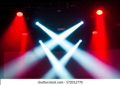 Stage Lights On Concert. Lighting Equipment With Red And Whit Beams On Dark Background 