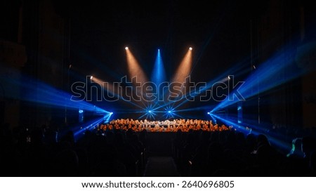 Stage Performance with Audience and Dynamic Lighting