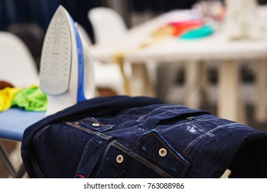 Stage processing denim jacket for the special effect of the old thing. Customization and decoration of jeans. Soft focus.