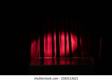 Stage with red curtain and spotlight on it. Theater, circus or cinema poster background with space for text. - Powered by Shutterstock