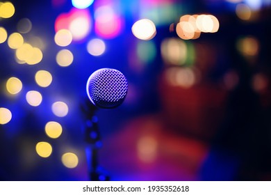 Stage and retro microphone. Microphone on the stand for public speaking, welcoming or congratulations speech. Abstract blurred background. - Powered by Shutterstock