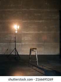 Stage in spotlights with chair. the spotlight shines on an empty chair. Real photo. Loft interior. Nobody. blank space - Shutterstock ID 2166695269