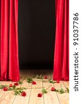stage theater with red curtain, wood floor and roses