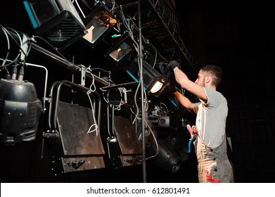 The Stage Worker Sets Up The Lights