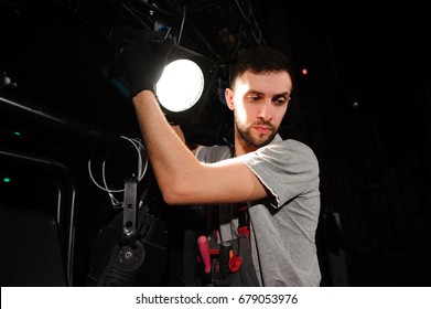 The stage worker sets up the lights - Powered by Shutterstock