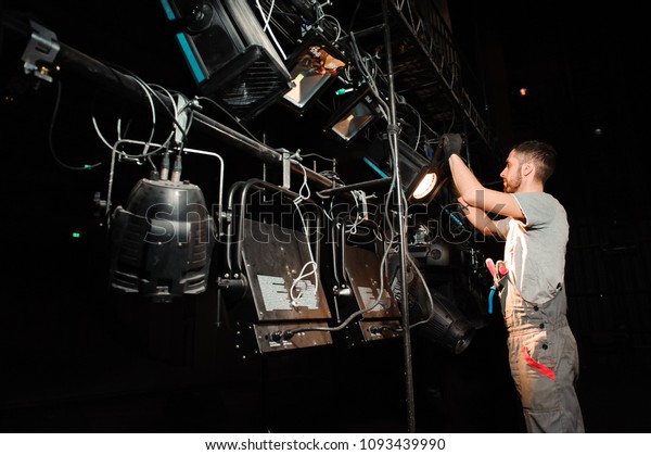 The stage worker sets up\
the lights