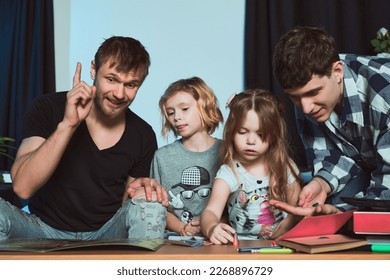   Staged photo  Homosexual couple   their children  two cute girls  at home                             