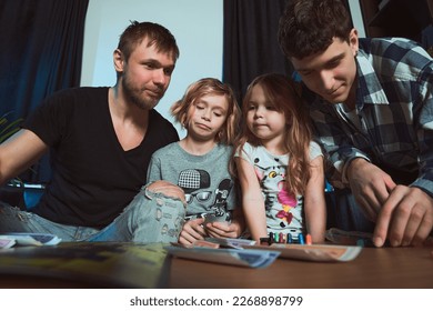   Staged photo  Homosexual couple   their children  two cute girls  at home                              