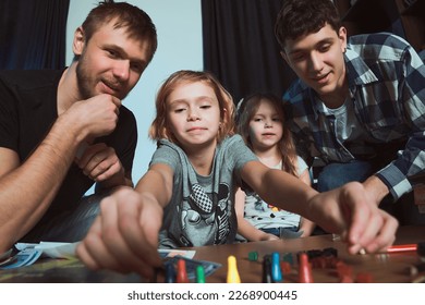   Staged photo  Homosexual couple   their children  two cute girls  at home  Everybody plays and delight  Go for it  girl! Who doesn't risk  doesn't win              