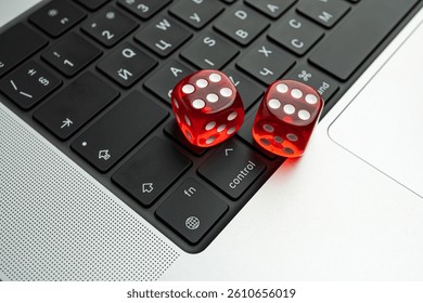 A staged photo of two numbered dice on a laptop keyboard, symbolizing randomness or decision-making in the context of technology