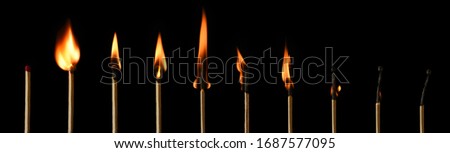 The stages of match burning on a black background. Safe match with red head. Different stages of matchstick burning. From Ignition to decay. Copy space, banner. 