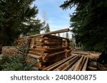 Stages of wood assembly of wooden log house at a construction base into the forest.